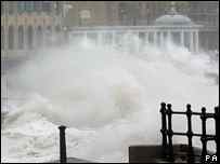 Photograph of wave breaking over seafront
