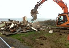 The first house is felled by a digger at Beach Road Happisburgh