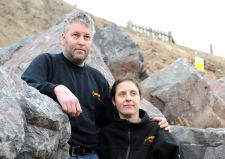 Castaway owners Anna and Richard Hollis at the base of the cliff
