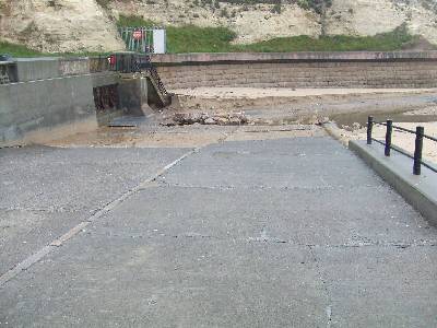 seafront showing discharge outlets and lifted tarmac