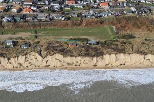 Bungalows along the dune edge at Hemsby North Marrams, those to the North of Hemsby Gap. Pat and Norma Gowen's is the second from the left, that nearest to the sea. Although the resulting levelling dune fall to restore equilibrium has yet to come, they may just about last  out the Summer.