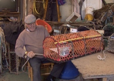 Fisherman Willie Cox mending pots